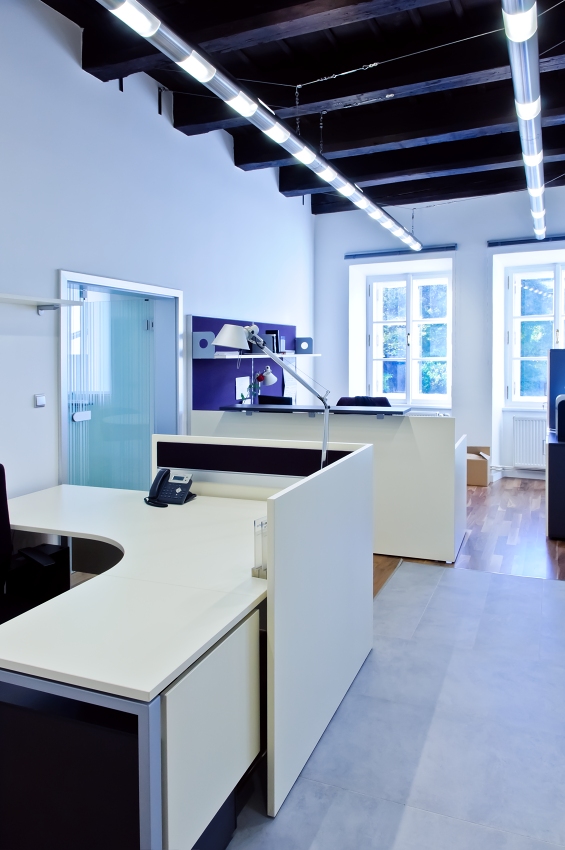 bright interior of a modern office with a white L-shaped desk